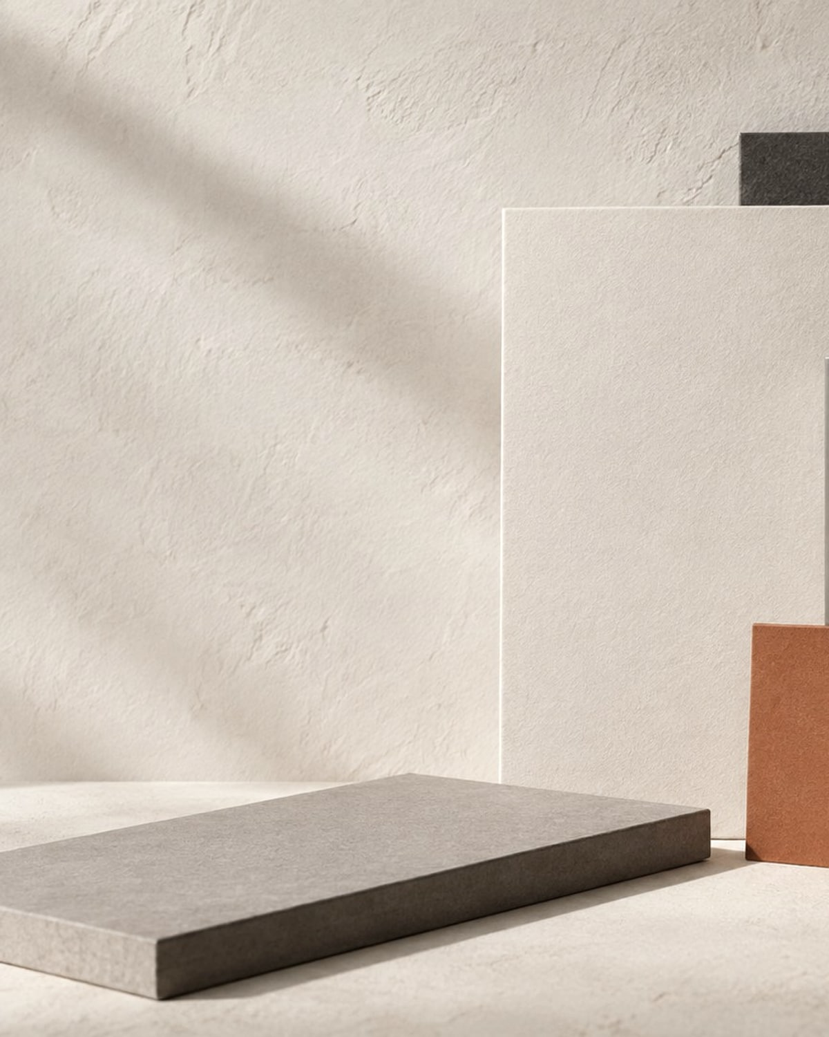 Brushed metal and warm paper material study in the ribbon colour grade.