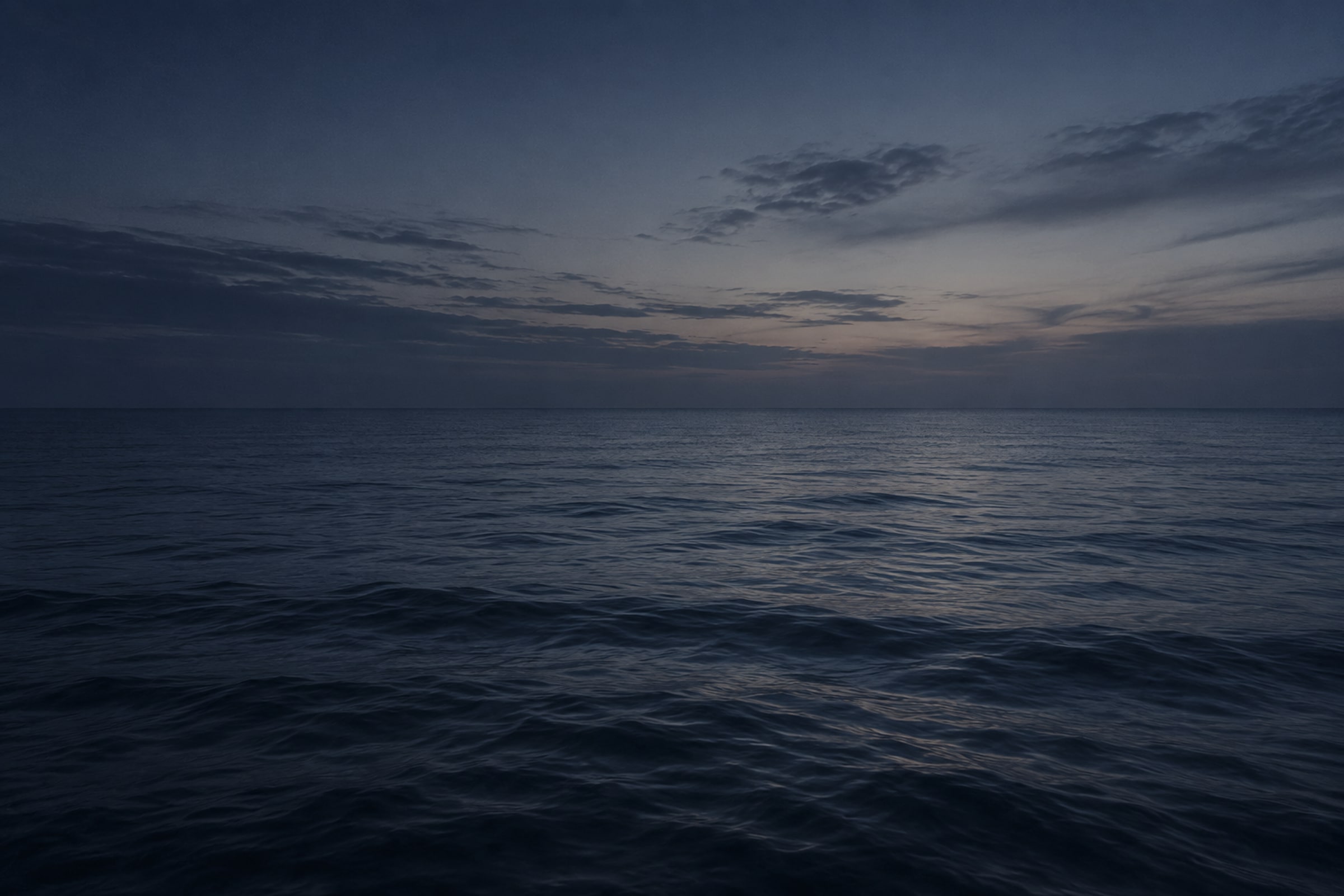 Empty sea horizon at blue hour in the orbit colour grade.