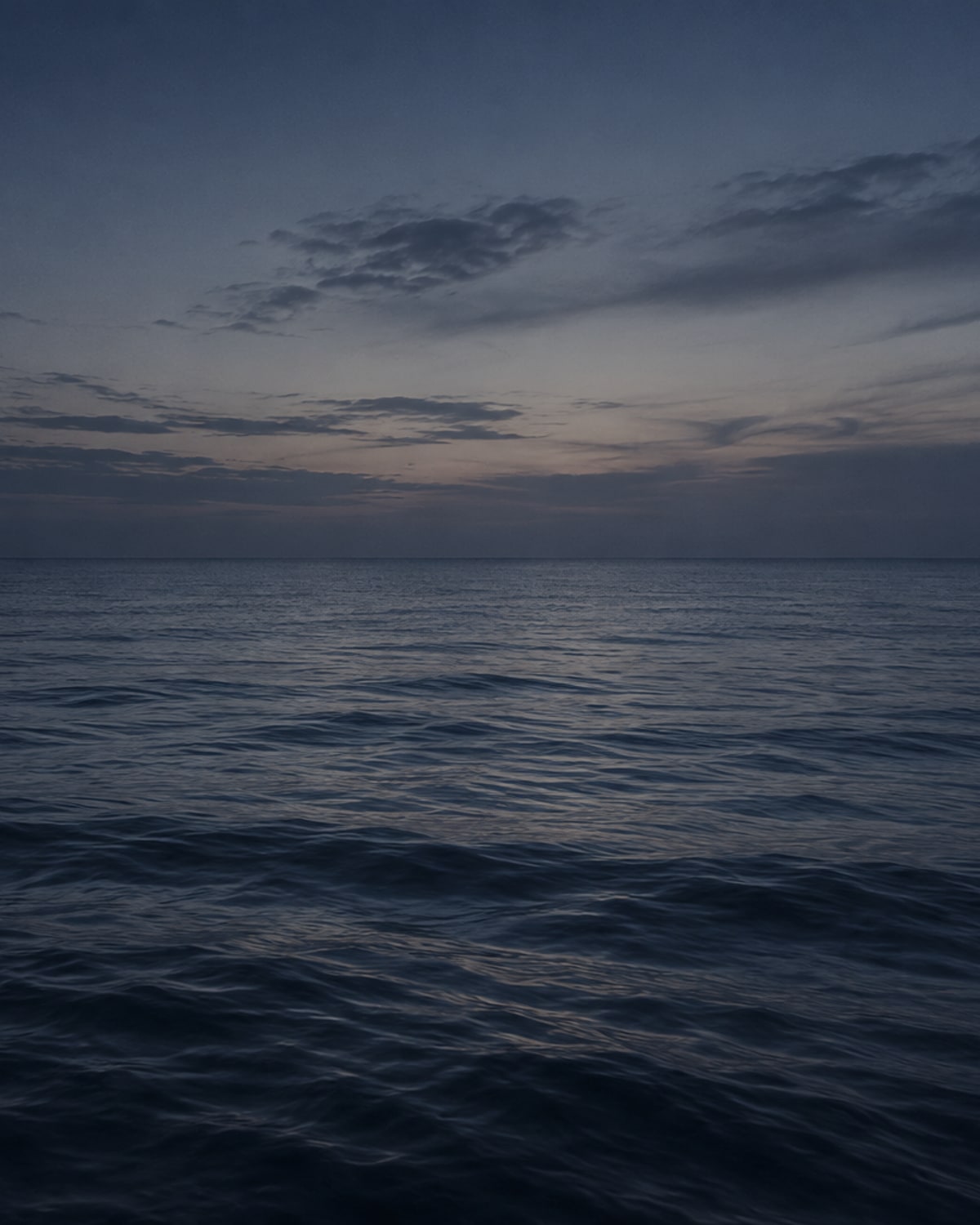 Empty sea horizon at blue hour in the orbit colour grade.